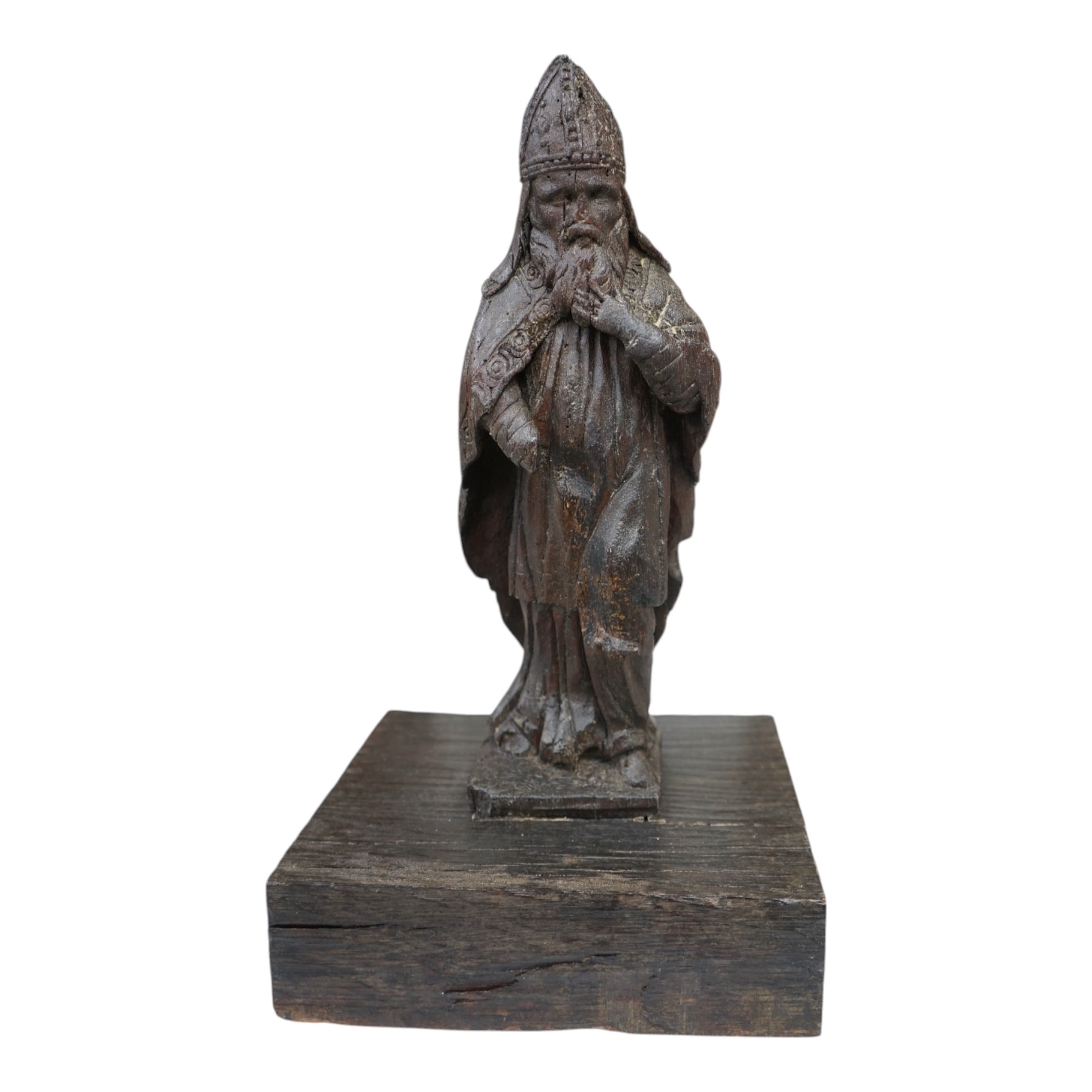 A North European oak carving of a bishop, possibly 17th/18th century, 38cm high not including stand. Condition - poor